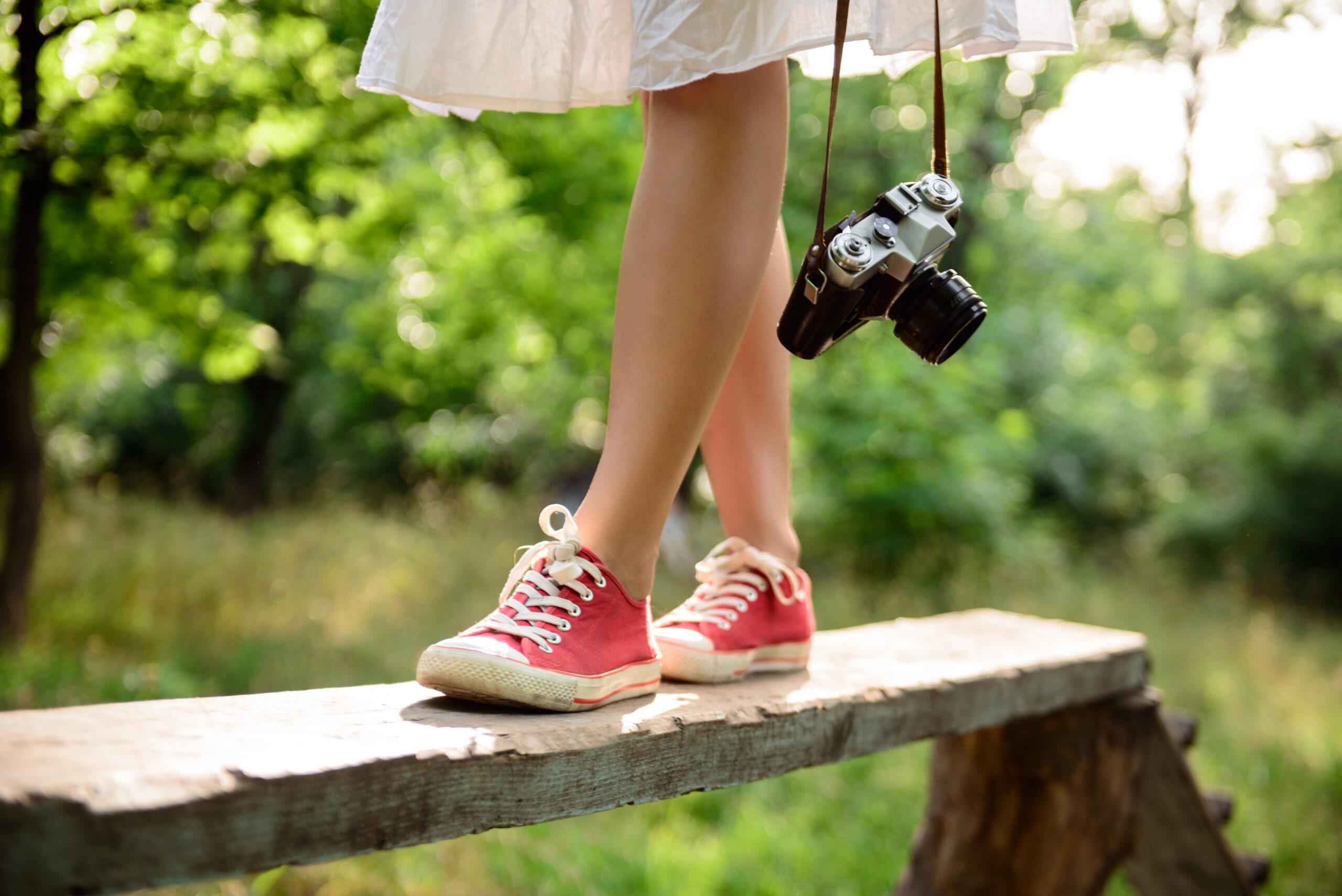 Walking meditation, a woman walking on a bench in a park, meditating and taking pictures of the surroundings
